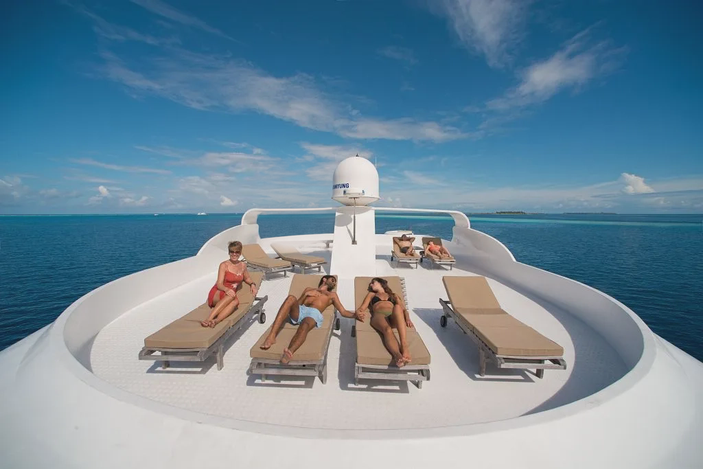 Guests relaxing on the Emperor Virgo sun deck in the Maldives